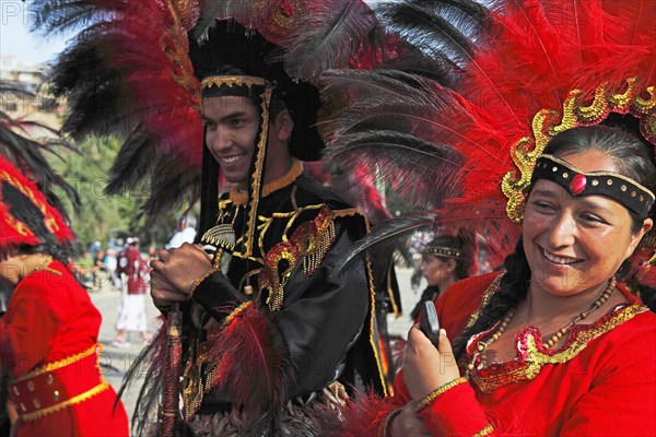 Man and woman wearing festive traditional Indio costumes