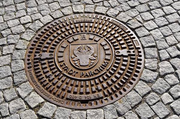Man-hole cover with inscription