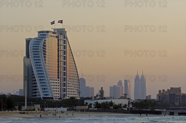 The illuminated Jumeirah Beach Hotel on Jumeirah beach at dusk