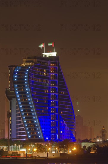 The illuminated Jumeirah Beach Hotel on Jumeirah beach at dusk