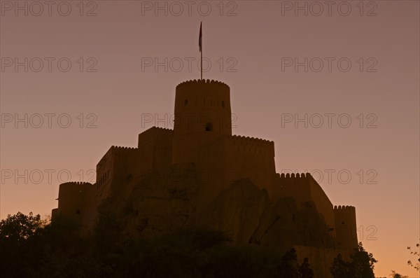 Nakhal Fort or Nakhl Fort back-lit by the setting sun