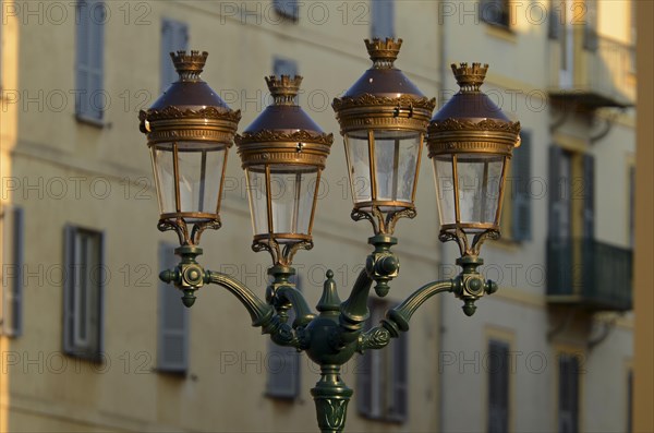 A glorious street lamp in Ajaccio and the facade of a house in the background illuminated by warm morning light. Ajaccio is the capital of the mediterranean island of Corsica