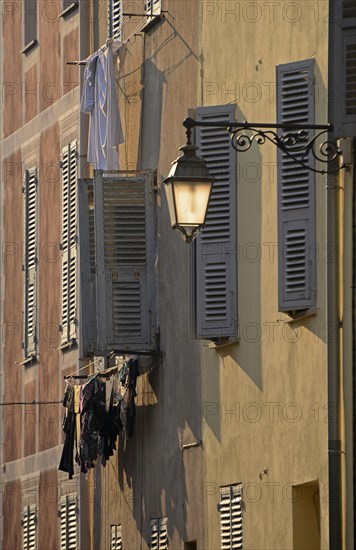 A street lamp and the facades of houses in Ajaccio. Ajaccio is the capital of the mediterranean island of Corsica