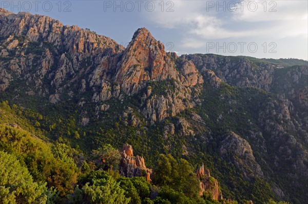 The typical bizarre red rocks of the Calanche of Pianasurrounded by green scrub. The Calanche of Piana is in the western part of the island Corsica