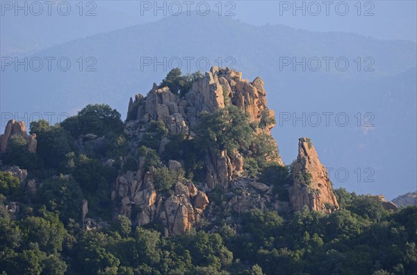 The typical bizarre red rocks of the Calanche of Piana below a blue sky. The Calanche of Piana is in the western part of the island Corsica