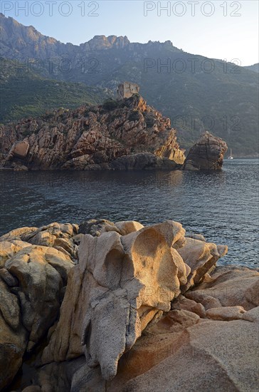 The Genoese Tower of Porto on top of a rocky hill and the Gulf of Porto