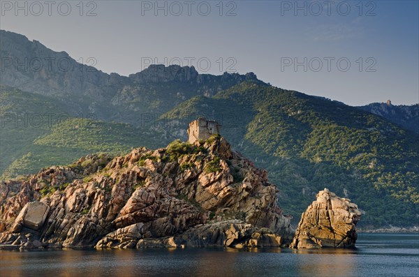 The Genoese Tower of Porto on top of a rocky hill and the Gulf of Porto
