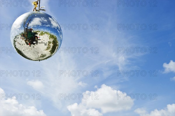 Mirror ball or disco ball against a blue sky