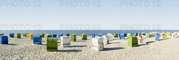 Colourful roofed wicker beach chairs
