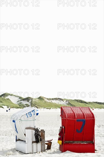 Beach chairs on the beach in front of dunes