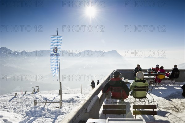 Mountain inn with a winter landscape and the sun