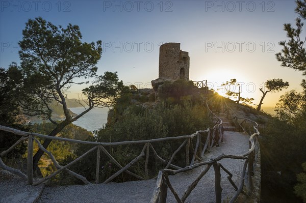 Old watchtower on the coast at sunset