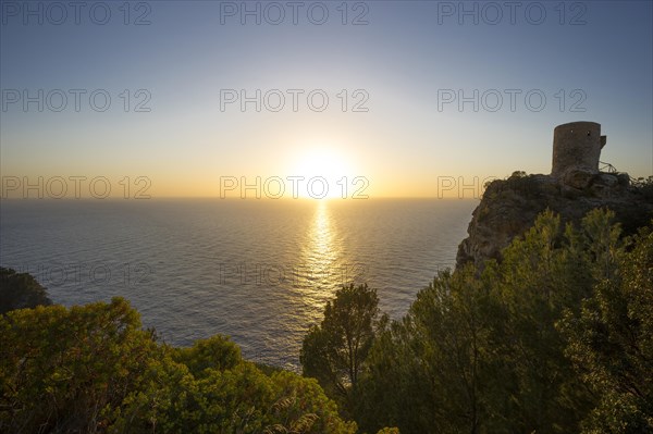 Old watchtower on the coast at sunset