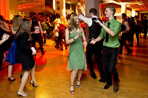 Young couple dancing at the prom of a dance school