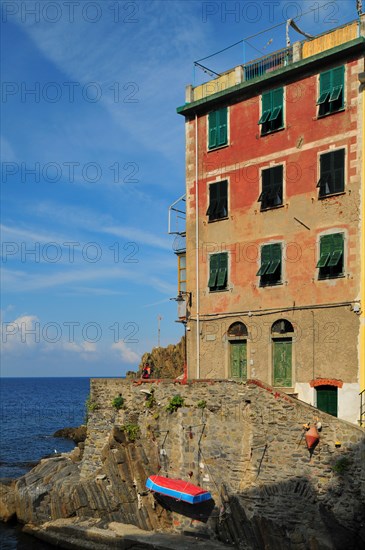 An aged house built right at the edge of the sea