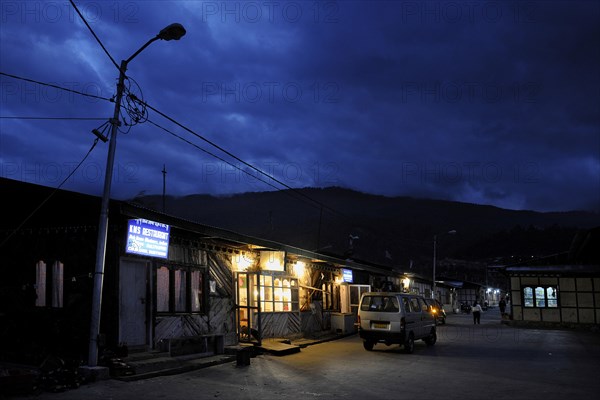 Evening street scene with a market store