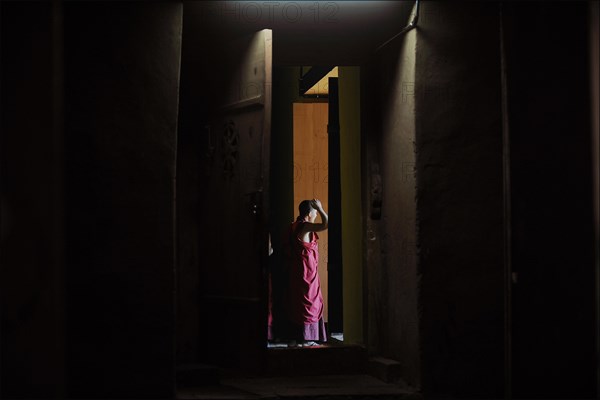 Monk leaving the room of a temple in Punakha Dzong fortress