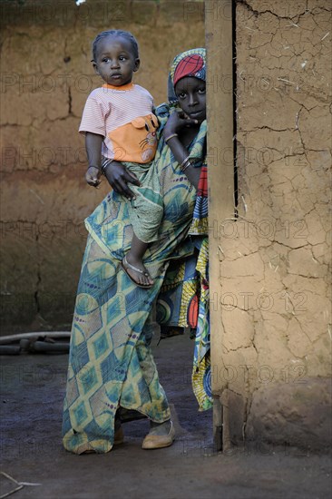 Young girl holding her younger sister in the village of Idool