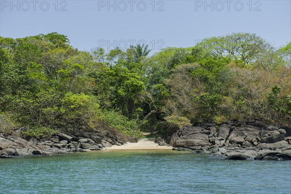 Sandy beach between rocks near the village