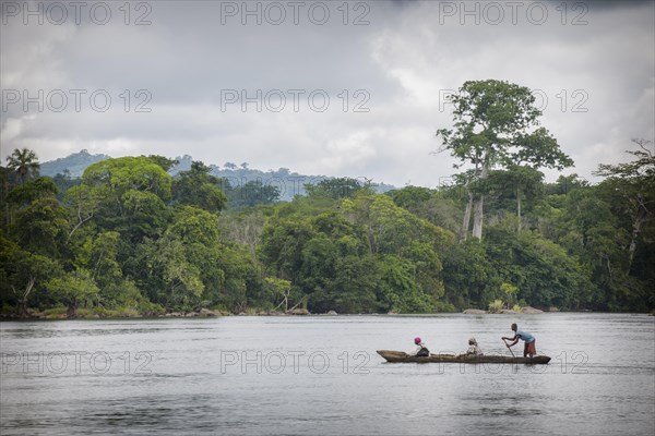 Ferryman taking passengers across the Moa River in a pirogue