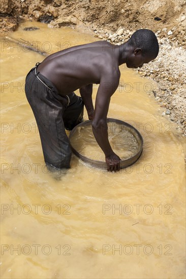 Worker washing gravel at a diamond mine