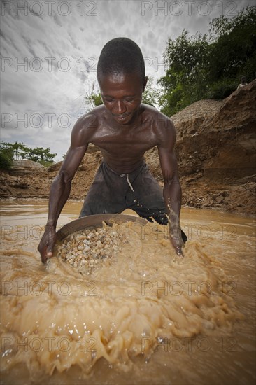 Worker washing gravel at a diamond mine