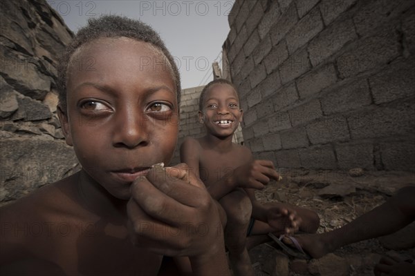 Children of the Rabelados religious community eating sea snails