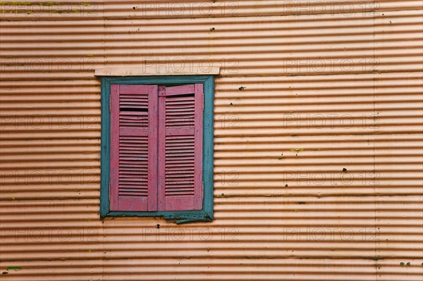 Closed shutters in a corrugated iron facade