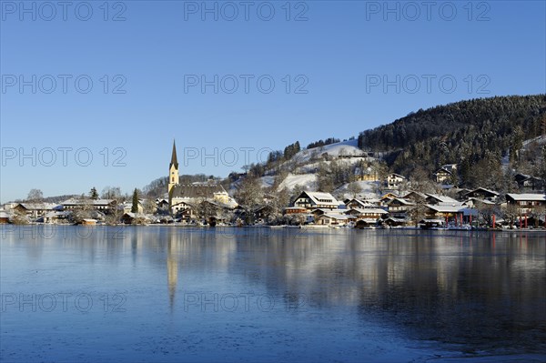 Lake Schliersee with the Church of St. Sixtus in winter