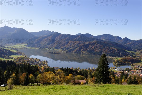 Lake Schliersee and the Parish Church of St. Sixtus as seen from Schliersberg mountain in autumn