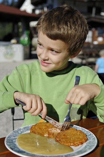 Boy eating hash browns