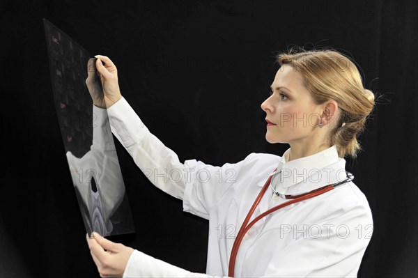 Young female doctor holding an X-ray