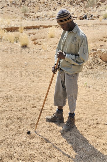 Young ranger on a trail to the White Lady rock painting in the Tsisab Gorge