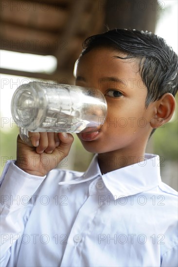 Boy drinking water from a glass