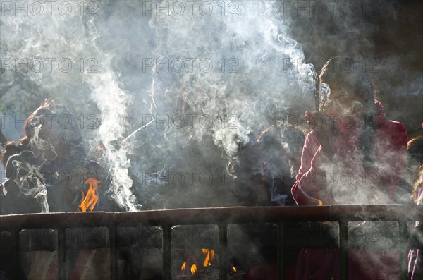 Pilgrims burning incense as an offering