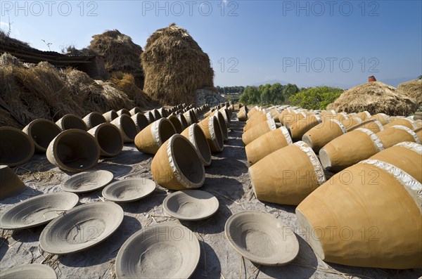 Newly made pottery is drying in the sun