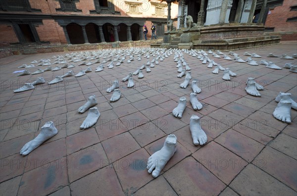 White sculptures of feet