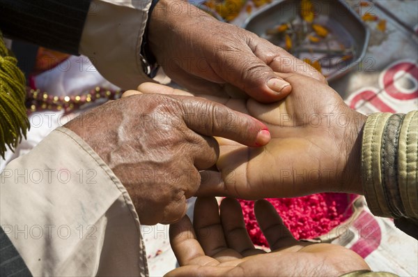 Palmist reading the hand of a customer