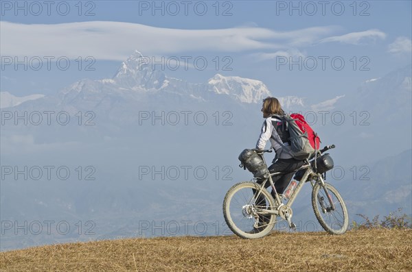 Cyclist leaning on his bike