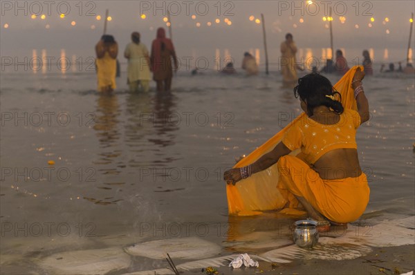 Woman washing her sari in the Sangam