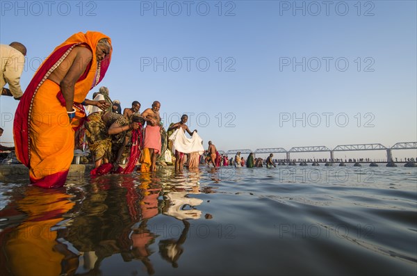 Crowds of people taking a bath in the Sangam