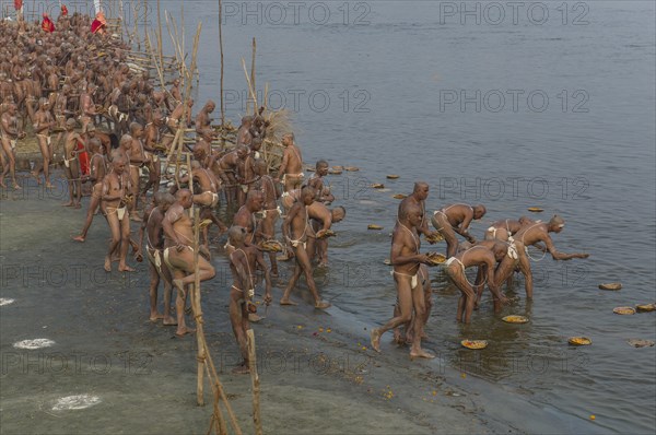 Offering parts of their first meal in their new lives as part of the initiation of new sadhus at the Sangam