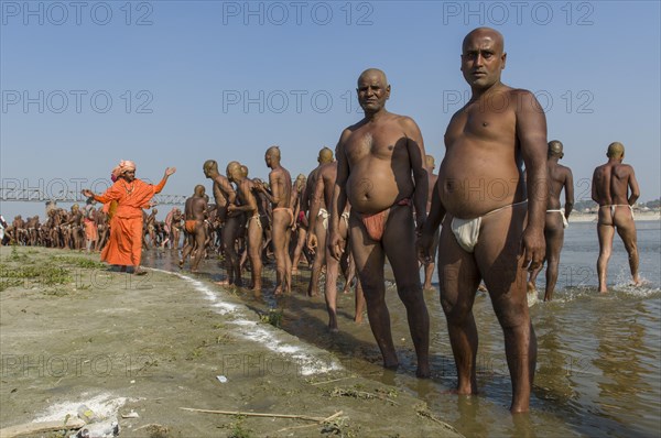 Group of men standing in the river Ganges