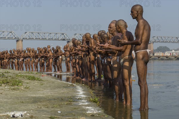 Group of men standing in the river Ganges