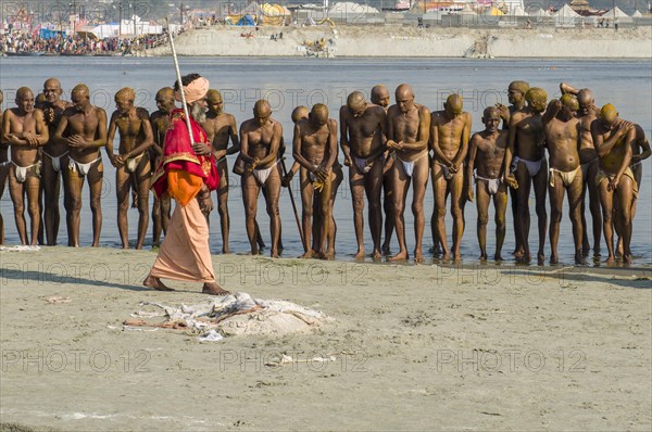 Group of men standing in the river Ganges