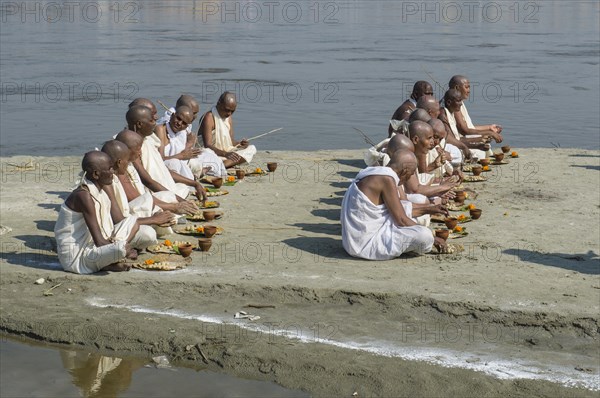 Group of new Jain nuns sitting at the banks of the river Ganges during their initiation