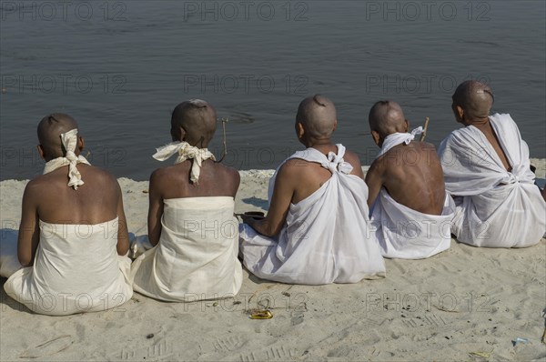 Group of new Jain nuns sitting at the banks of the river Ganges during their initiation