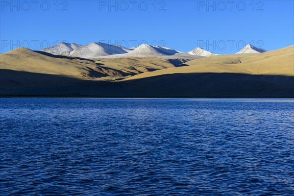 Snow covered mountains behind Tsomoriri or Lake Moriri