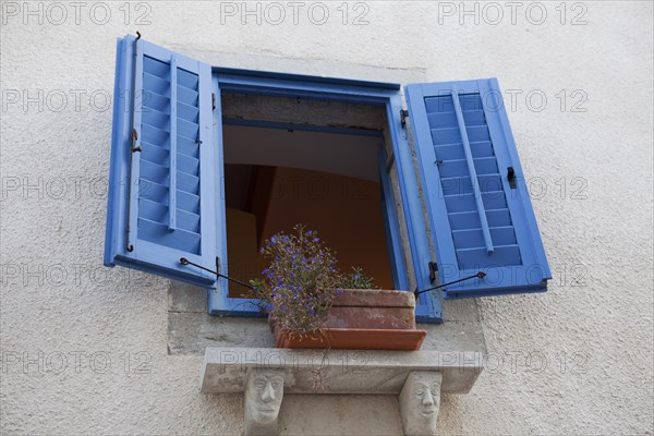Window with blue shutters