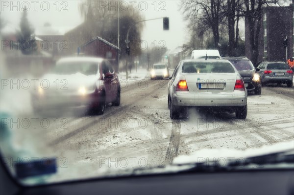 View through the windscreen of a car turning left at at crossroads